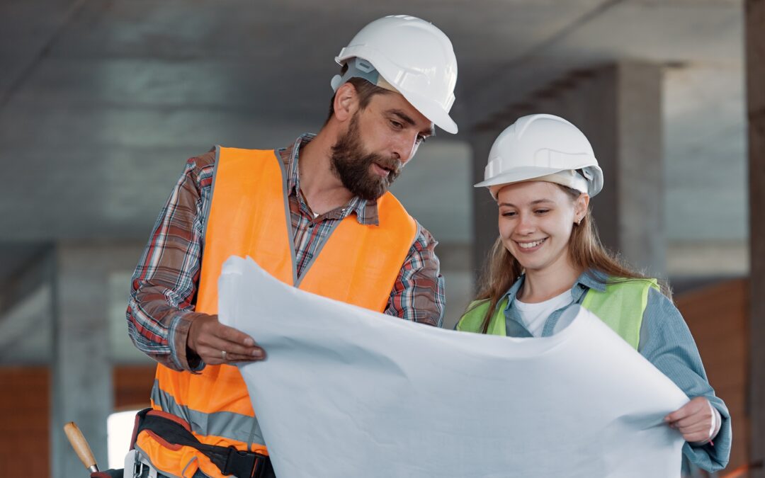 Self build mortgage, Man and woman looking at blueprint on building site