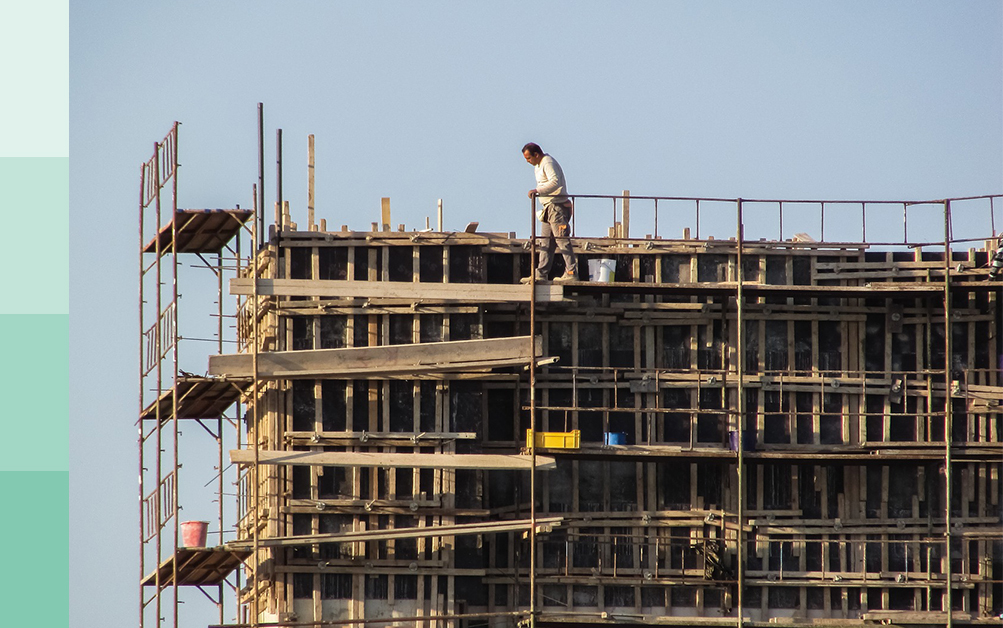 construction sites, image shows a worker on scaffolding on a construction site