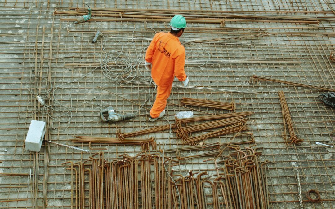 Image of a site worker walking away from a small pile of materials to demonstrate the material shortage in the UK
